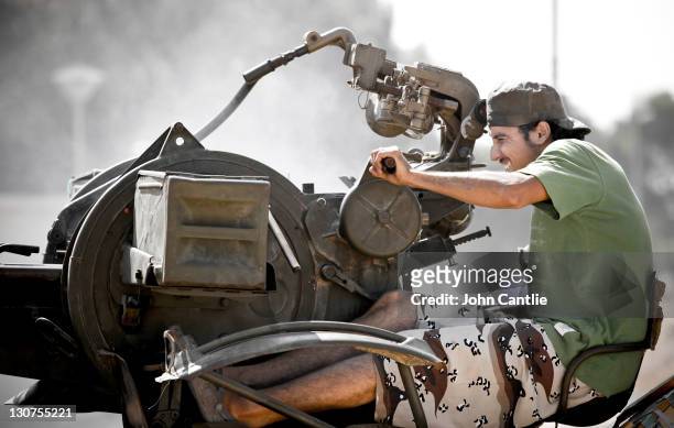 An NTC fighter sits in the new gun conversion on his Toyota Land Cruiser made in Misrata on October 8, 2011 in Tripoli, Libya. Fighting in Libya has...