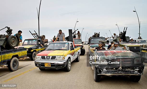 Gun trucks muster before a decision is made on which route to advance on October 3, 2011 in Misrata, Libya. Fighting in Libya has ceased following...