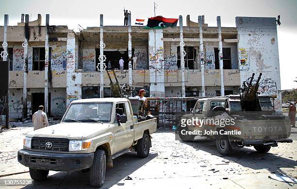 Brand new Toyota Land Cruisers taken from Gaddafi's military and now used in the strikes against loyalist forces are parked outside the former...