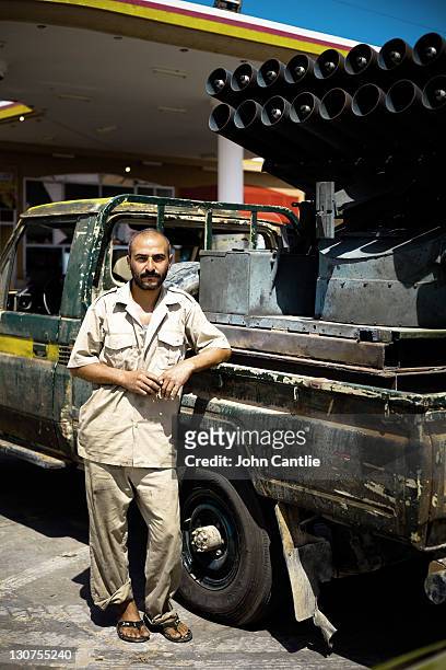 Yousef Masimir a veterinarian by trade and now known as the biggest builder of gun truck conversions in the Misrata area poses at his garage on...