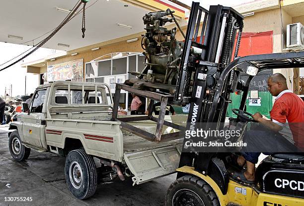 Mechanics load a new 23mm anti-aircraft gun onto the bed of a Toyota Land Cruiser on September 4, 2011 in Misrata, Libya. Fighting in Libya has...