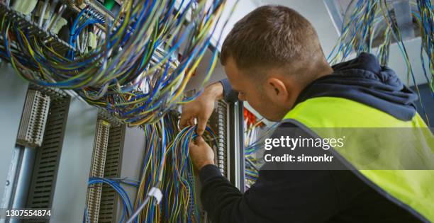 electrician working at construction site - distribution board stock pictures, royalty-free photos & images