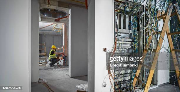 elektriker arbetar på byggarbetsplats - cable bildbanksfoton och bilder