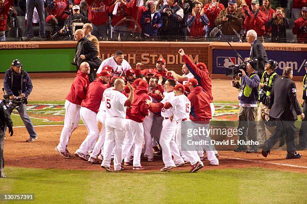 World Series: St. Louis Cardinals players pile up, victorious on field after 11th inning walk-off win vs Texas Rangers at Busch Stadium. Game 6. St....