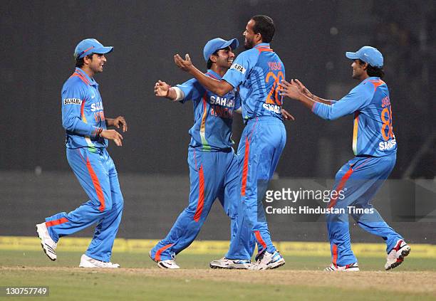 Indian bowler Yusuf Pathan celebrates with teammates after taking the wicket of England batsman Alex Hales during the Twenty20 International match...