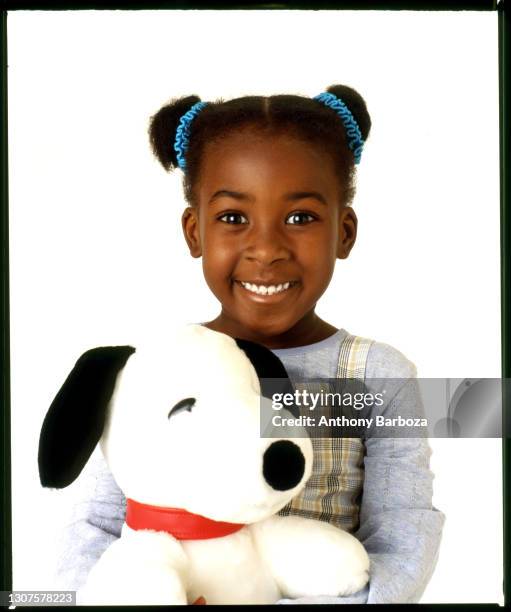 Portrait of an unidentifed child model as she poses with a stuffed 'Snoopy' doll, November 22, 2008.