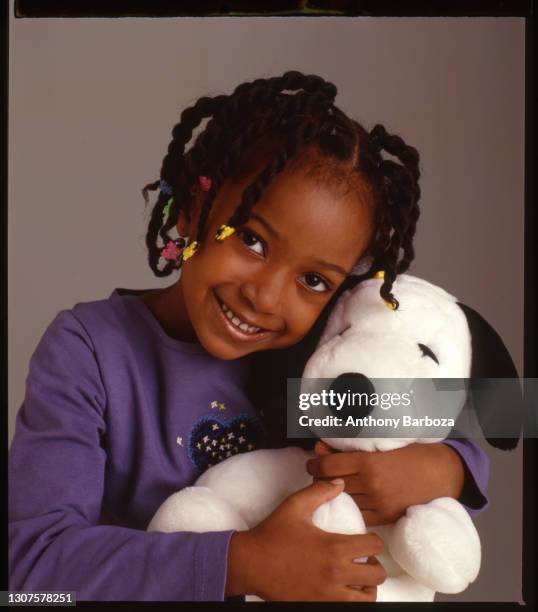 Portrait of an unidentifed child model as she poses with a stuffed 'Snoopy' doll, November 22, 2008.