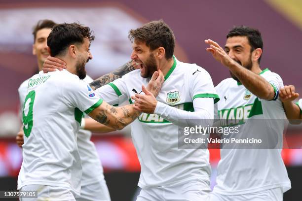 Domenico Berardi of Sassuolo celebrates with Francesco Caputo after scoring his sides first goal during the Serie A match between Torino FC and US...