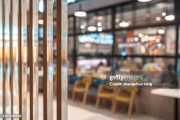 people eating in a restaurant inside a large open shopping mall - blurred motion restaurant stock pictures, royalty-free photos & images