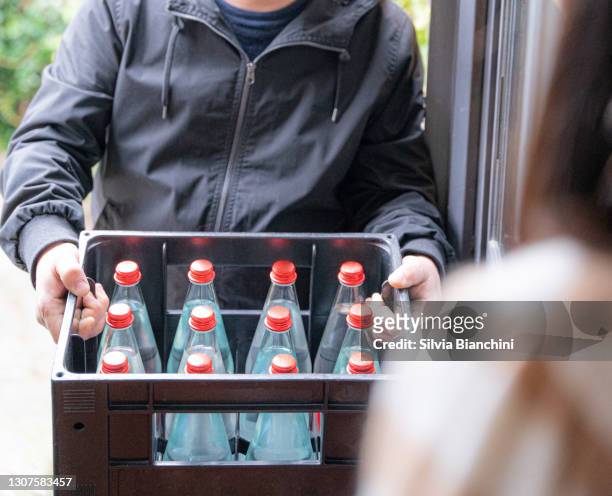 close-up of water bottles delivery - giving a box stock pictures, royalty-free photos & images