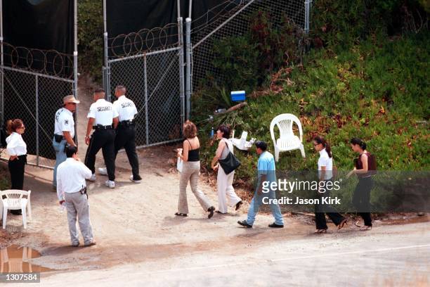 Guests are escorted July 29, 2000 by security into the wedding of Brad Pitt and Jennifer Aniston in Malibu, CA.