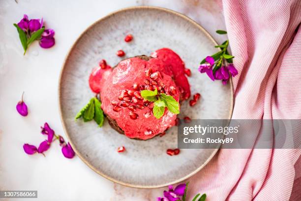 chocolate protein pancakes with berry sauce and pomegranate seeds - protein pancakes stock pictures, royalty-free photos & images