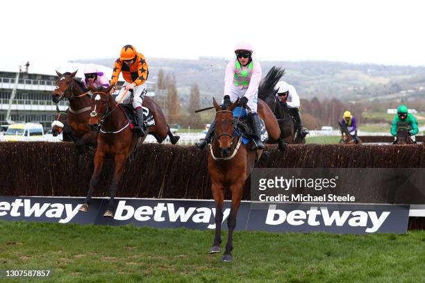 Greaneteen ridden by Harry Cobden, Put The Kettle On ridden by Aidan Coleman and Chacun Pour Soi ridden by Paul Townend jump a fence during the...