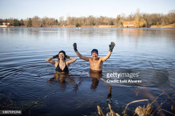 couple enjoying refreshing bath in cold water - eis baden stock-fotos und bilder
