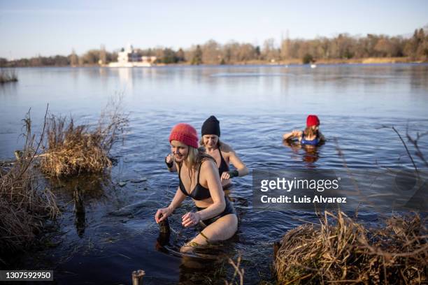 women coming out of lake after a swim - people coming of age purify with icy water in tokyo stockfoto's en -beelden