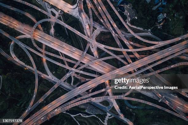 top view of road intersection and busy traffic at dusk - chongqing stock pictures, royalty-free photos & images