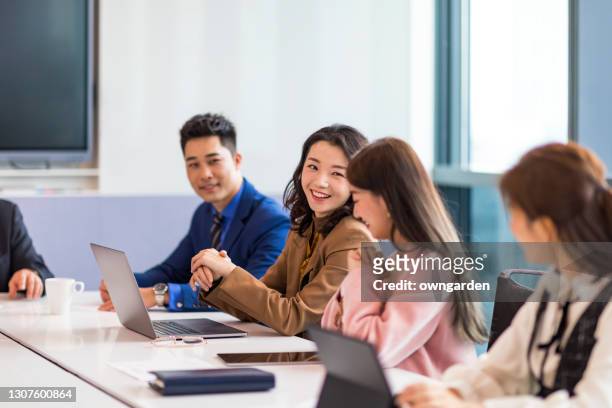 business colleagues discussing in the meeting room - asia stock pictures, royalty-free photos & images