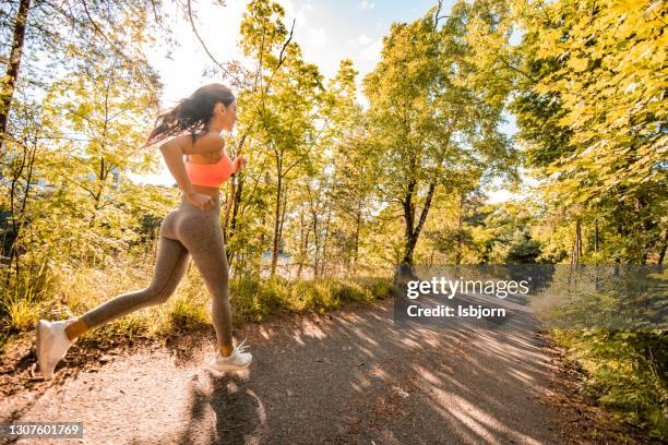 fit woman running at park - norway womens training session stock pictures, royalty-free photos & images