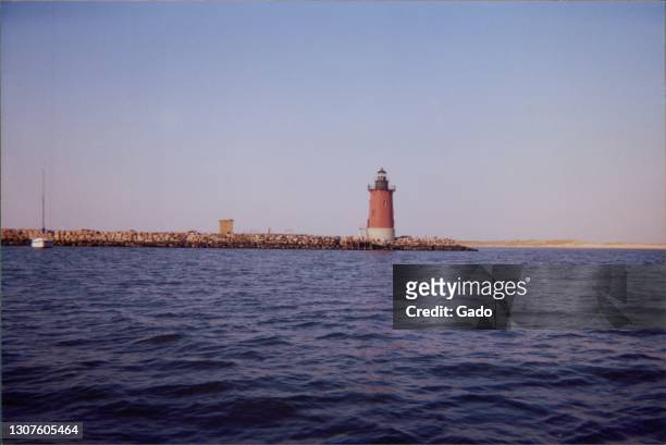 Wide-shot of the Delaware Breakwater East End Light, a sparkplug lighthouse set at the end of the Delaware Breakwater in the Delaware Bay, near Cape...