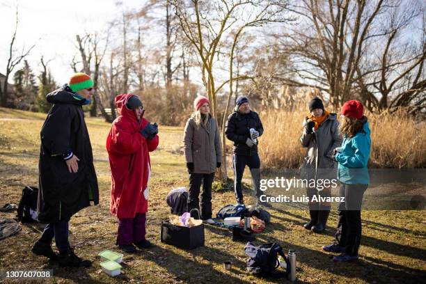 adult hobby group standing together in forest - discussion germany outdoor friends stock-fotos und bilder