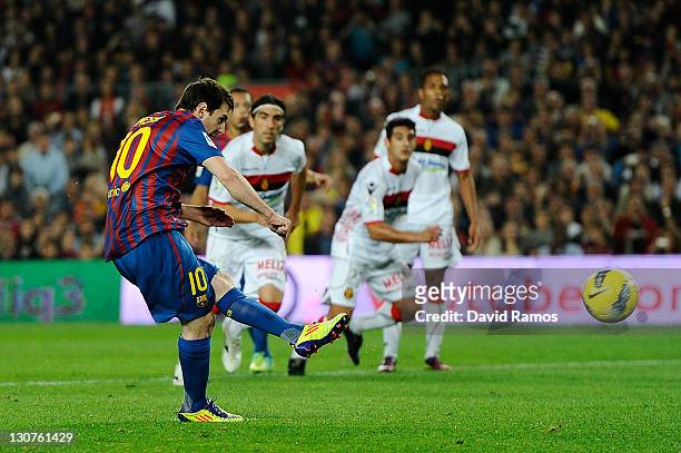 Lionel Messi of FC Barcelona scores the opening goal during the La Liga match between FC Barcelona and RCD mallorca at Camp Nou on October 29, 2011...