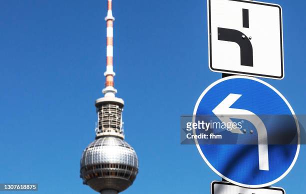 television tower berlin with left direction arrow (germany) - national lefties bildbanksfoton och bilder