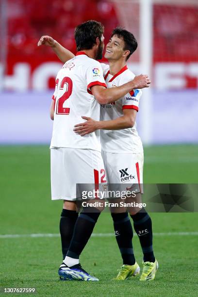 Franco Vazquez of Sevilla FC celebrates with teammate Oliver Torres after scoring their team's second goal during the La Liga Santander match between...