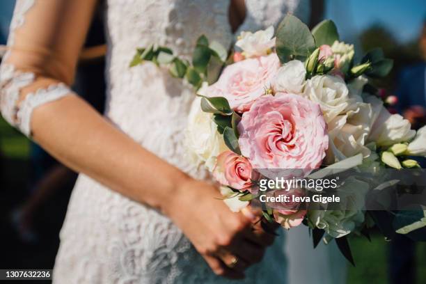 close up of wedding pink and white bouquet bride in white dress holds in her hands detail - cerimonia di nozze foto e immagini stock