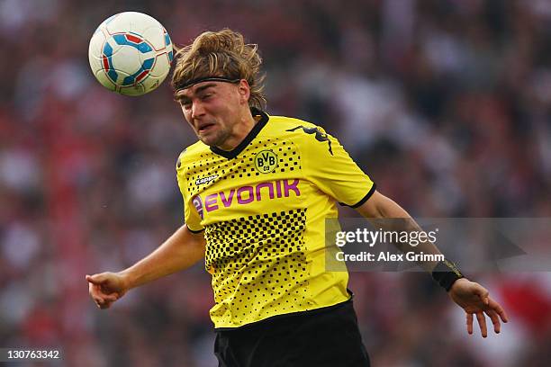 Marcel Schmelzer of Dortmund heads the ball during the Bundesliga match between VfB Stuttgart and Borussia Dortmund at Mercedes-Benz Arena on October...