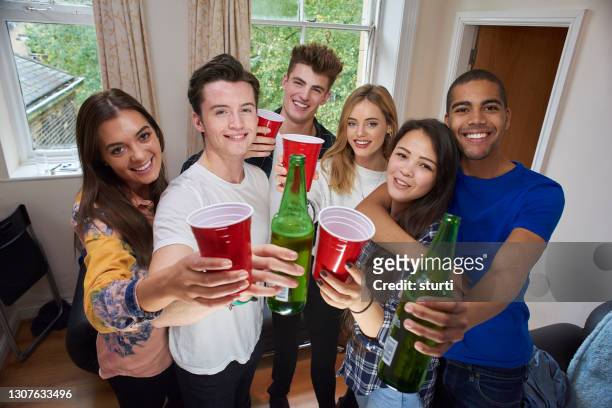 student gang cheers - college dorm party stock pictures, royalty-free photos & images