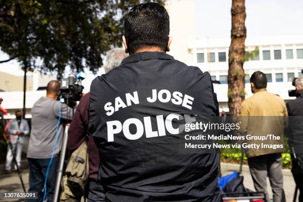 Person wears a San Jose Police jacket during a press conference outside of the San Jose Police department in San Jose, Calif., on Wednesday, March...