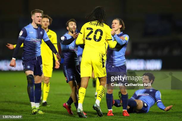 Toby Sibbick of Barnsley FC tassles with Dominic Gape of Wycombe Wanderers during the Sky Bet Championship match between Wycombe Wanderers and...