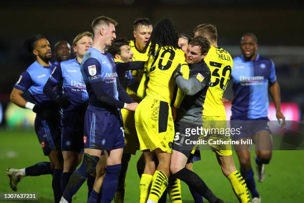 The players clash as tempers flare after a challenge between Toby Sibbick of Barnsley FC and Joe Jacobson of Wycombe Wanderers during the Sky Bet...