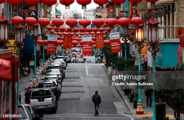 Pedestrian crosses Grant Avenue in Chinatown on March 17, 2021 in San Francisco, California. The San Francisco police have stepped up patrols in...