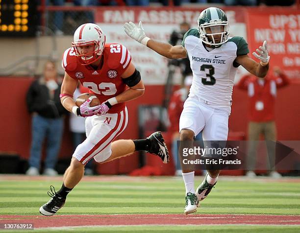 Defensive back Lance Thorell of the Nebraska Cornhuskers takes the ball away from wide receiver B.J. Cunningham of the Michigan State Spartans during...