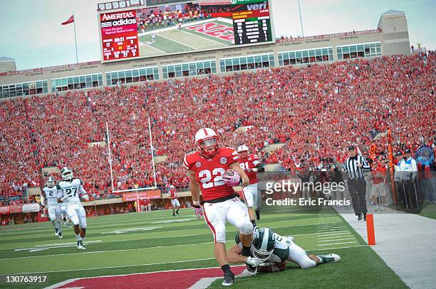 Running back Rex Burkhead of the Nebraska Cornhuskers scores a second half touchdown against the Michigan State Spartans defense during their game at...