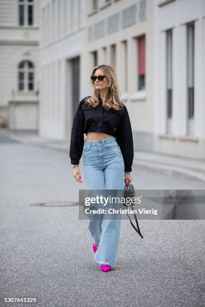 Mandy Bork is seen wearing black Zara jeans and cropped jacket, Balenciaga heels, Linda Farrow sunglasses, Dior bag on March 16, 2021 in Berlin,...