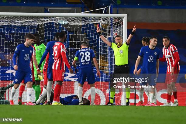 Stefan Savic of Atletico Madrid is shown a red card and sent off by referee Daniele Orsato for a clash with Antonio Ruediger of Chelsea during the...