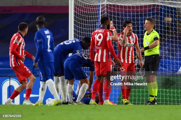 Stefan Savic of Atletico Madrid complains after being shown a red card and sent off by referee Daniele Orsato for a clash with Antonio Ruediger of...