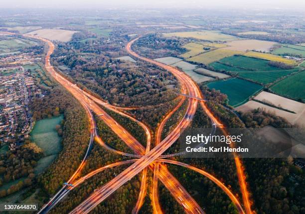 an aerial view of a uk motorway / freeway system at dawn - stock photo - motorway uk stock pictures, royalty-free photos & images