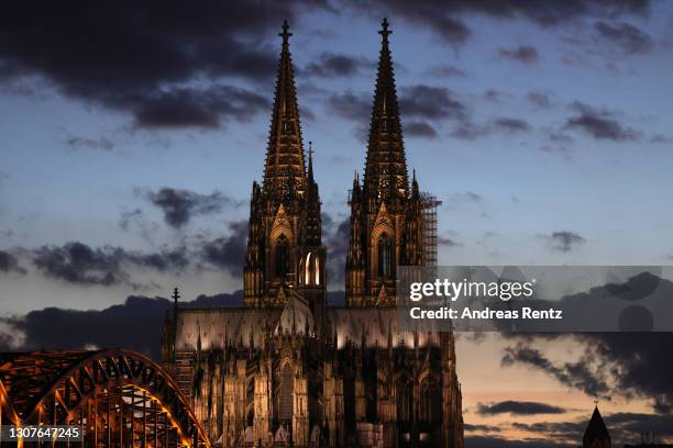 The Cologne Cathedral stands in twilight on March 17, 2021 in Cologne, Germany. The Catholic Church is facing a number of challenges in Germany,...
