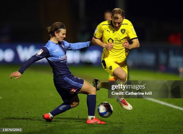 Dominic Gape of Wycombe Wanderers tackles Herbie Kane of Barnsley during the Sky Bet Championship match between Wycombe Wanderers and Barnsley at...