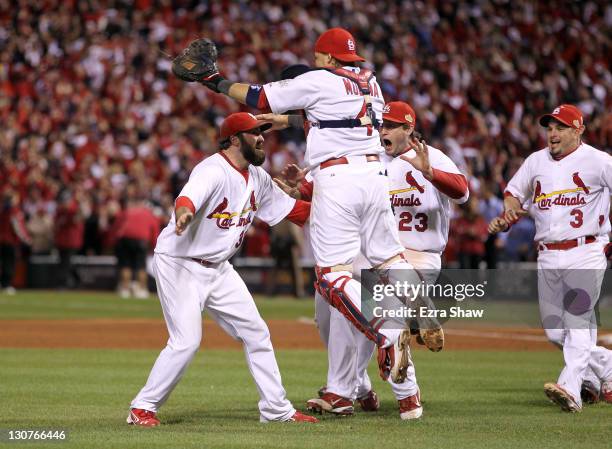 Jason Motte and Yadier Molina of the St. Louis Cardinals celebrate after defeating the Texas Rangers 6-2 to win Game Seven of the MLB World Series at...