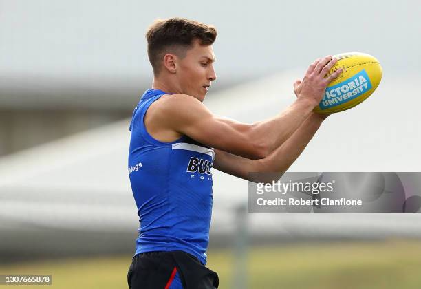 Anthony Scott of the Bulldogs takes the ball during a Western Bulldogs AFL training session at Whitten Oval on March 18, 2021 in Melbourne, Australia.