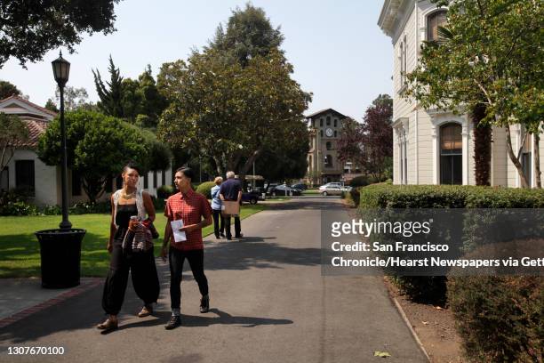 Partners Barbara Jefferson left, and Sonj Basha walk through the campus in search of food after visiting financial aid August 7, 2014 at Mills...