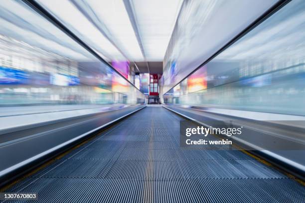 moving walkway at the airport - airport corridor stock pictures, royalty-free photos & images