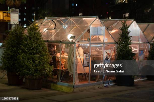 People dine in house tents outside a restaurant in Madison Square Park amid the coronavirus pandemic on March 17, 2021 in New York City. After...