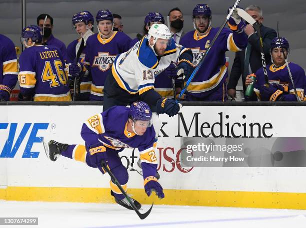 Kyle Clifford of the St. Louis Blues takes a hit from Jaret Anderson-Dolan of the Los Angeles Kings during the first period at Staples Center on...