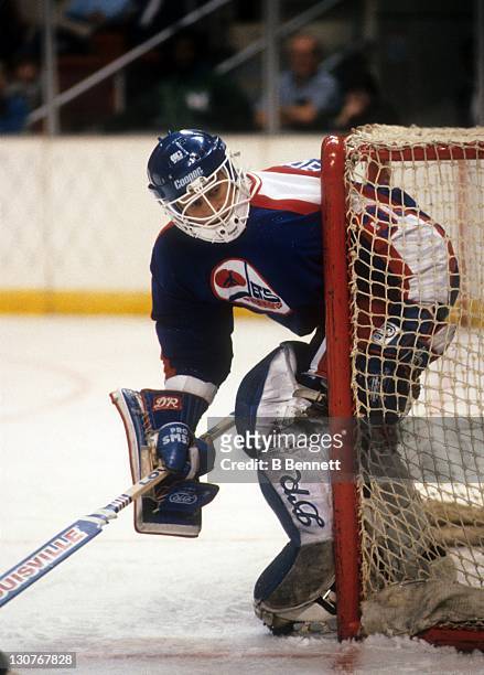 Goalie Dan Bouchard of the Winnipeg Jets defends the net during an NHL game against the New Jersey Devils on November 26, 1985 at the Brendan Byrne...