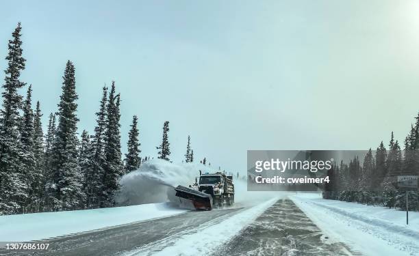snow plow clearing alaskan highway - snowplow stock-fotos und bilder